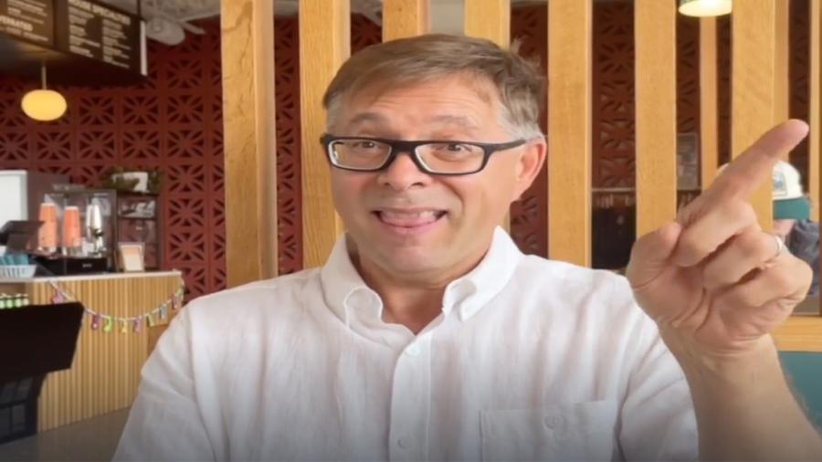 Lewis Lummer speaks American Sign Language at a coffeeshop. 